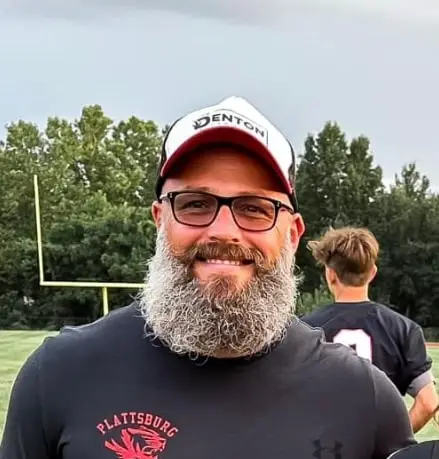 Smiling man in a Denton cap, from the Meet Us section