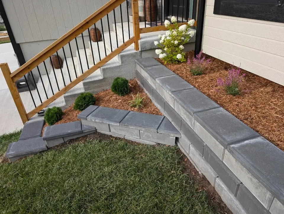 Block edging and mulch bed along porch steps
